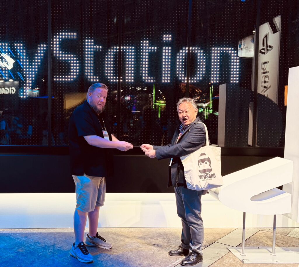 Yoshida and former colleague Adam Boyes exchanging sony playstation discs 1