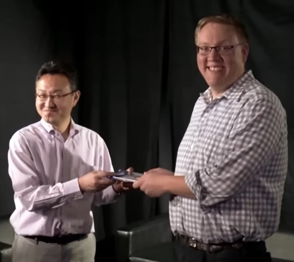 Yoshida and former colleague Adam Boyes exchanging sony playstation discs 1